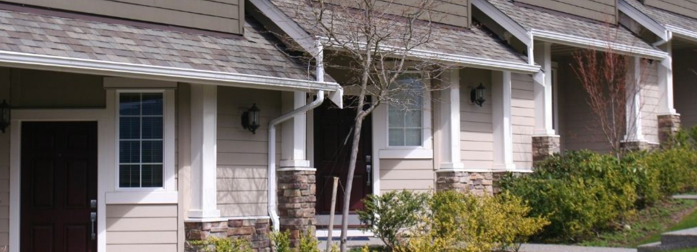 A welcoming craftsman-style home with a covered porch and front garden in a quiet Delta neighbourhood.